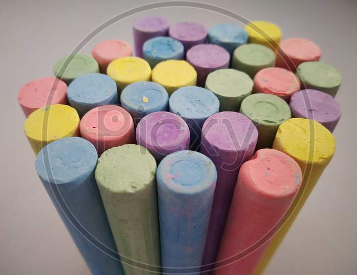 Colourful chalks on white background