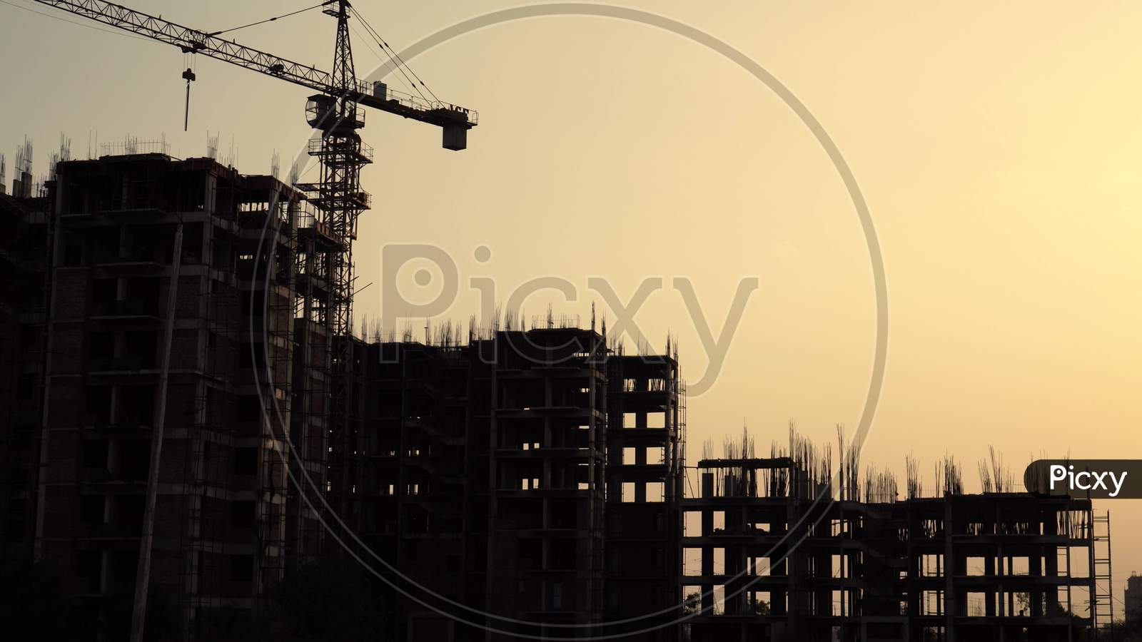 Silhouette Shot Of Buildings Under Construction With A Crane On The Top And Support Beams Clearly Visible Shot In Delhi, India