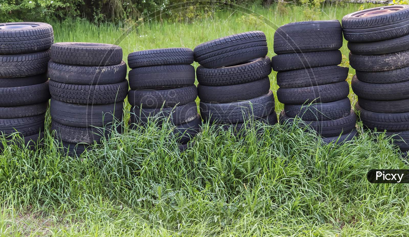 Damaged and worn old black tires on a stack. Tire tread problems. Solutions concept. Tire tread problems.