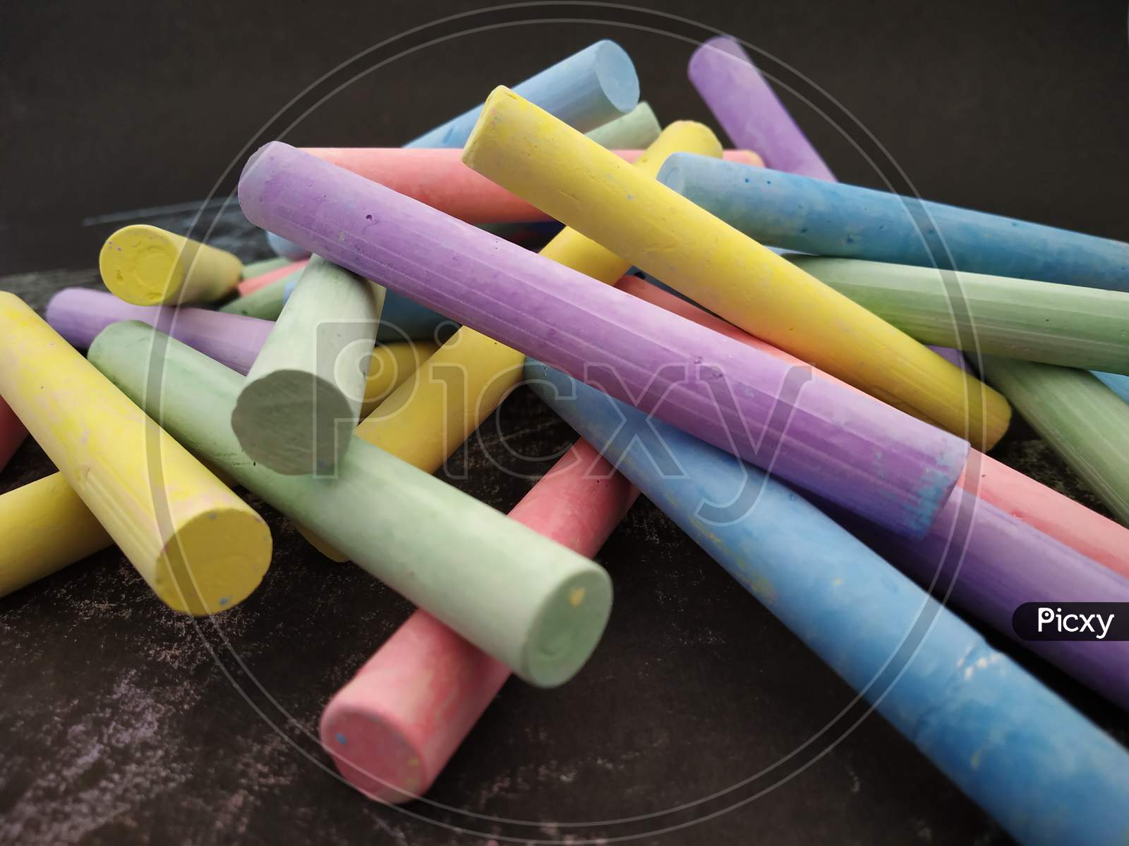 Collection of Colourful chalks on black background
