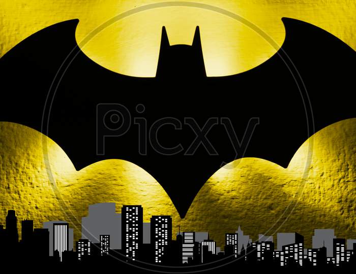 The bat signal light from the Gotham cityscape