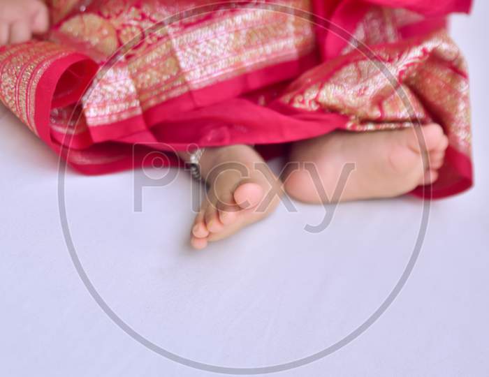 Indian child leg at rice feeding ceremony in India