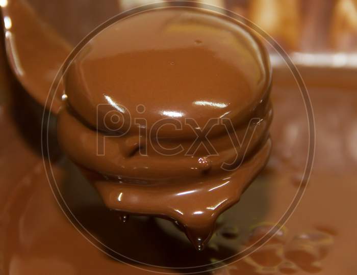 Preparation Of Alfajores Of Dulce De Leche Bathed In Chocolate