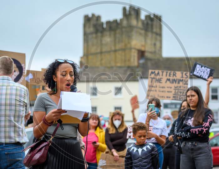 A Female Speaker In Front Of Richmond Castle At A Black Lives Matter Protest In The Marketplace In Richmond, North Yorkshire