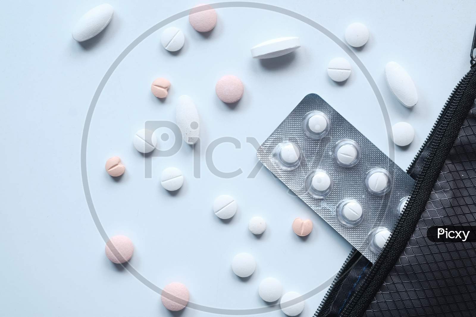 Top View Of White Pills Spilling On White Desk