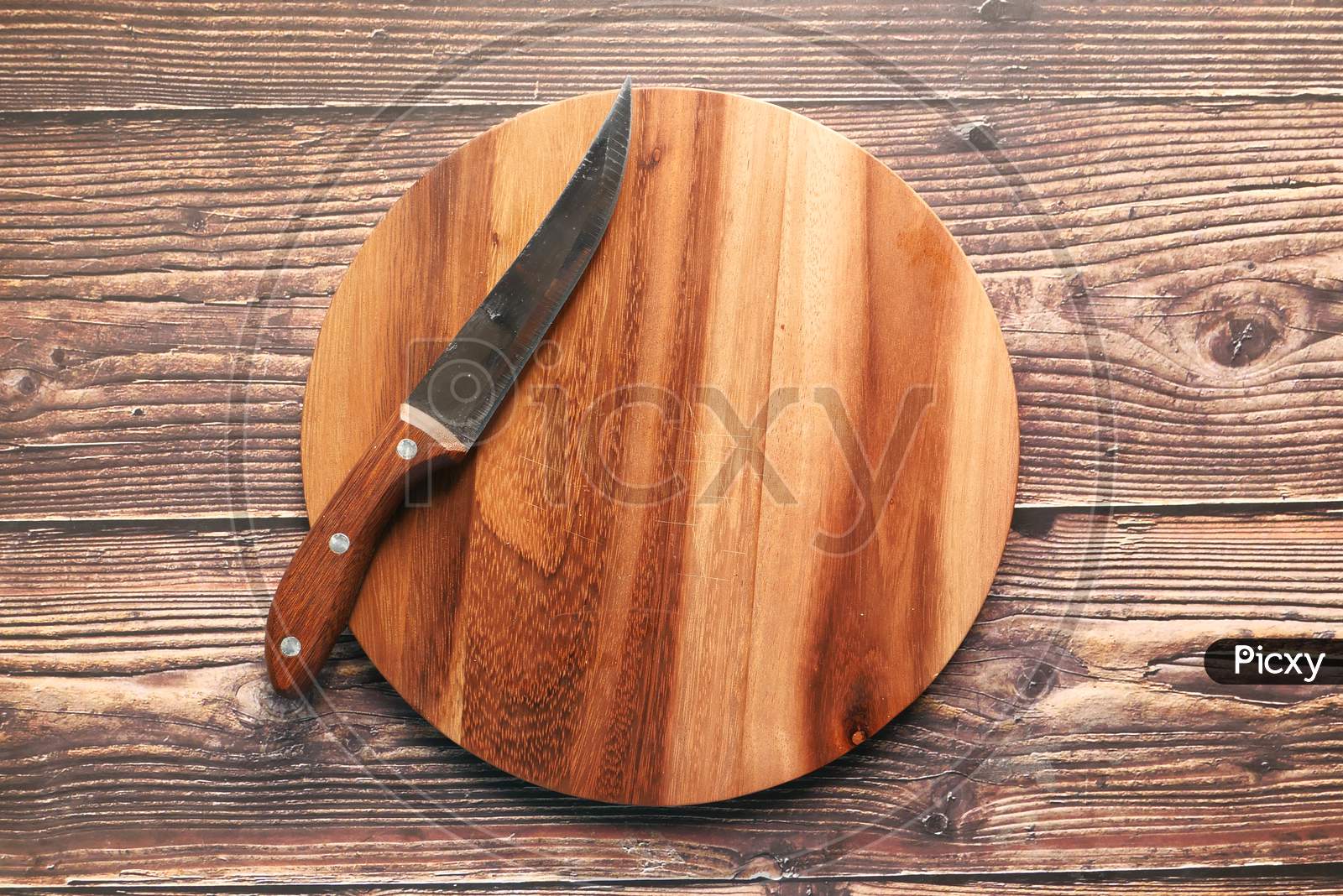 Top View Of Wooden Chopping Board On Gray Background .