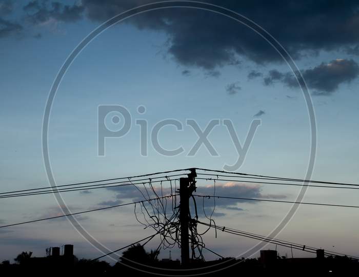 Cluster Electric Pole With Wires Background Dark Clouds With Sillhoutte
