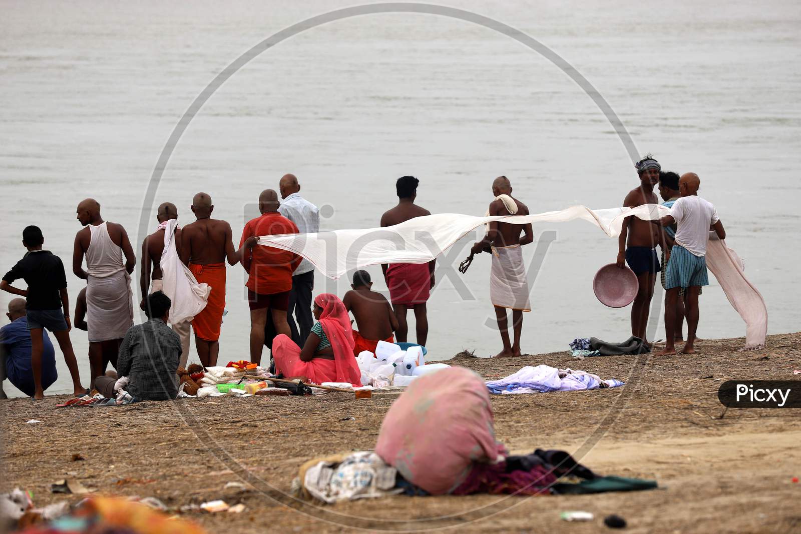 Hindu Devotees Dry Their Clothes After Taking Holy Dip In River Ganga In Prayagraj, June 14, 2020.