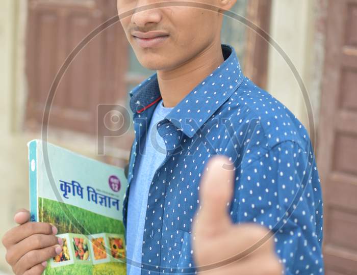 indian student with book in hand