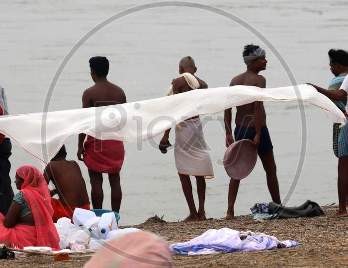 Hindu Devotees Dry Their Cloth After Taking Holy Dip In River Ganga In Prayagraj, June 14, 2020.