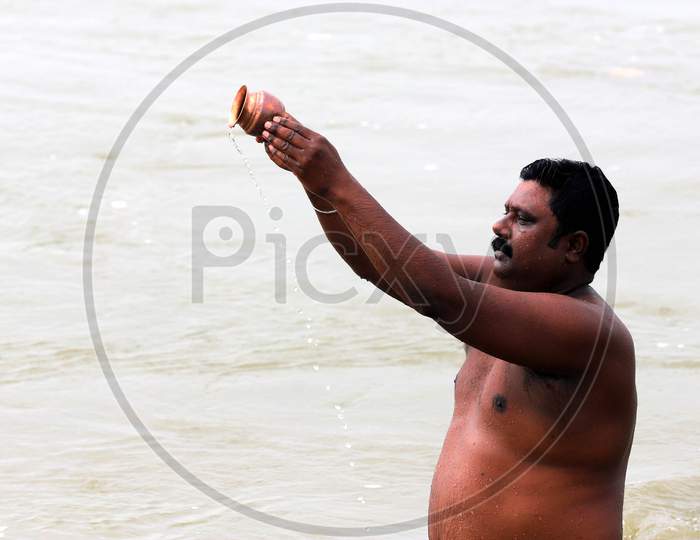 A Hindu Devotee Offering Prayers In The Ganga River In Prayagraj, June 14, 2020.