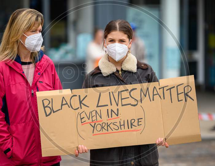 Two White Female Protesters Hold A Homemade Black Lives Matter Placard At An Anti-Racism Protest In Richmond, North Yorkshire