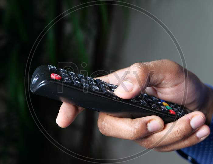 Close Up Of Man Hand Holding Tv Remote.
