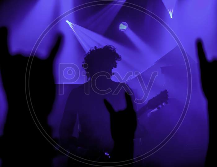 Krakow, Poland - September 20, 2014: Abstract Background Image Of An Artist From A Rock Band Music Concert In Front Of Crowd