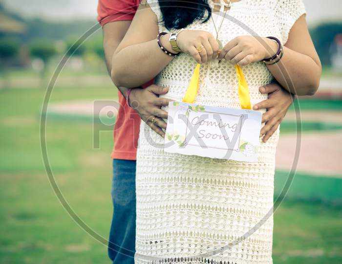 Indian couple posing for a maternity moment