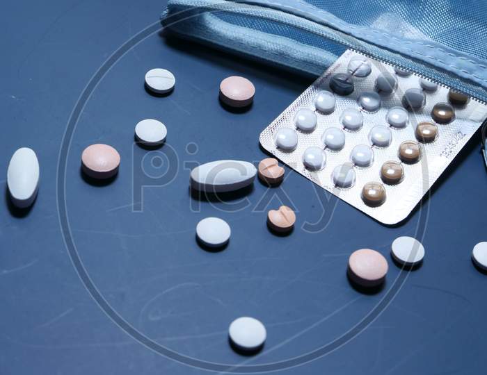 Birth Control Pills On Blue Background, Top View