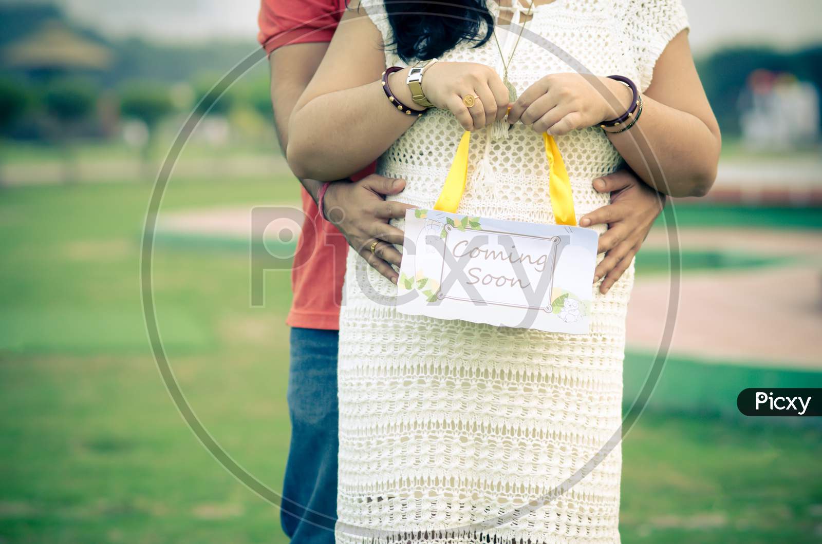 Indian couple posing for a maternity moment
