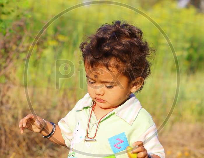 A Little Child Playing In The Nature