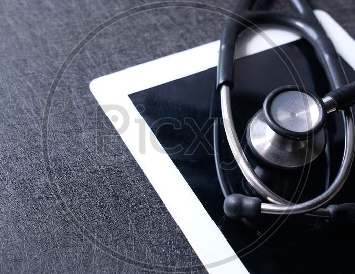 Medical Stethoscope On Modern Digital Tablet On White Background