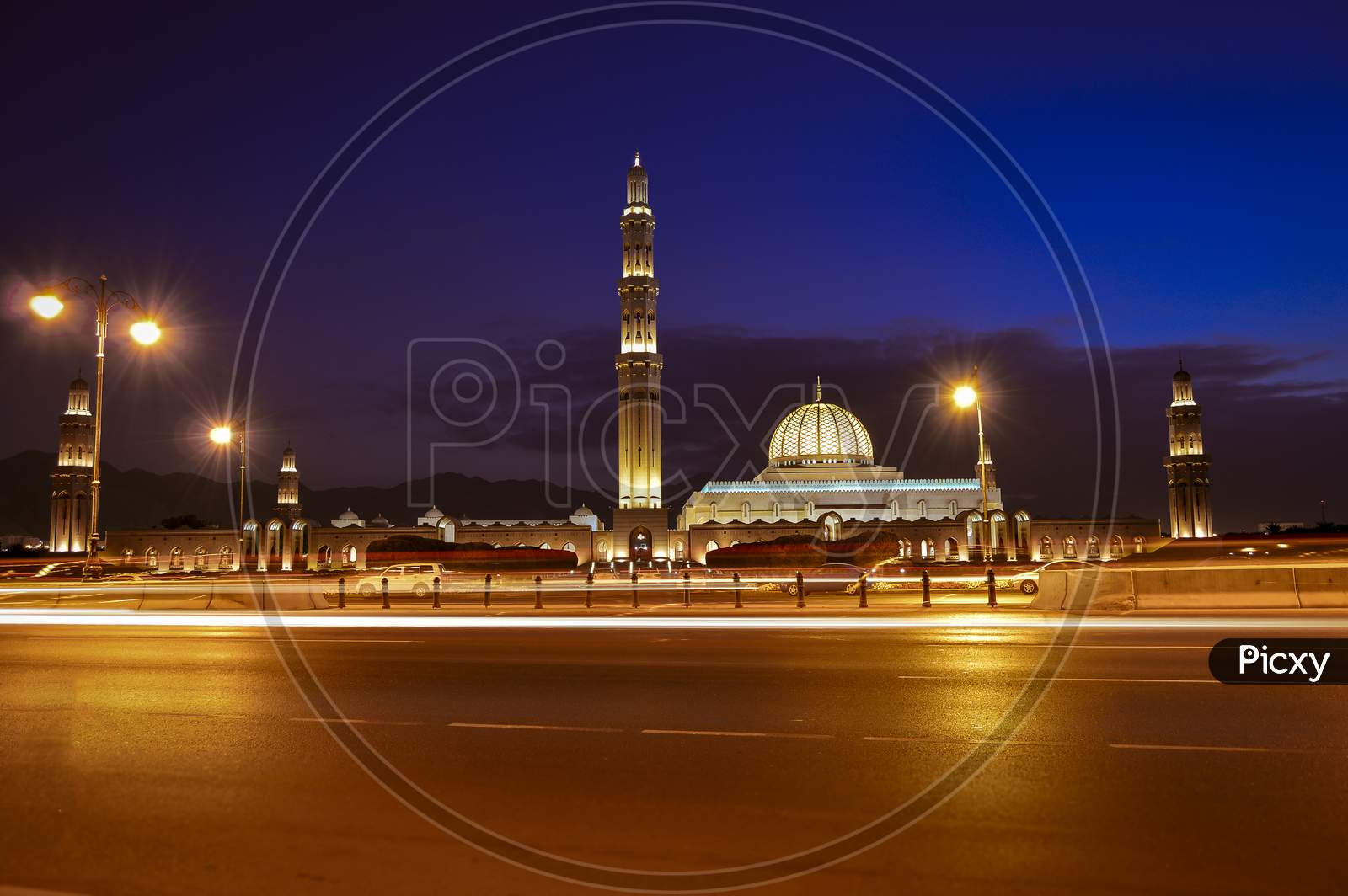 Sultan Quaboos Grand Mosque Of Oman, Muscat With Lights In The Evening.