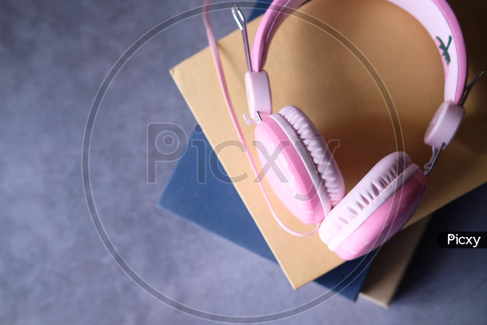 Audio Book Concept. Headphones And Book Over Wooden Table.