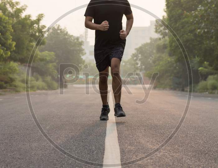 A Man Running While Wearing Mask In The Morning.