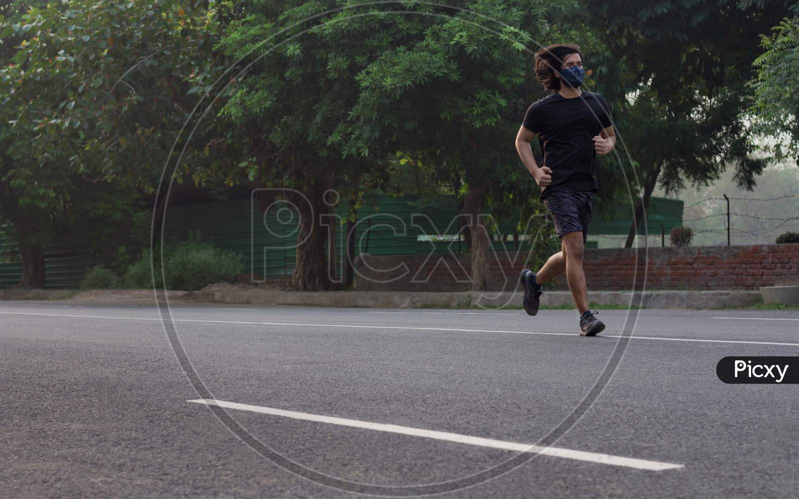 A Man Running While Wearing Mask.