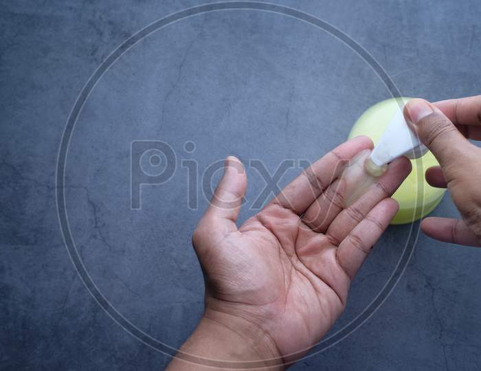Man'S Hands Using Hand Sanitizer Gel, Top View