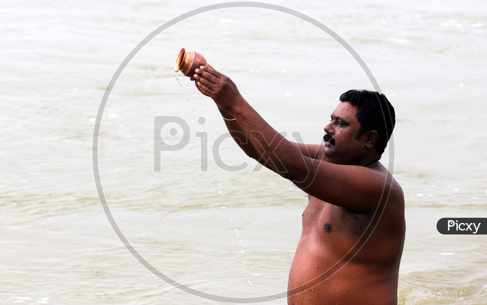 A Hindu Devotee Offering Prayers In The Ganga River In Prayagraj, June 14, 2020.