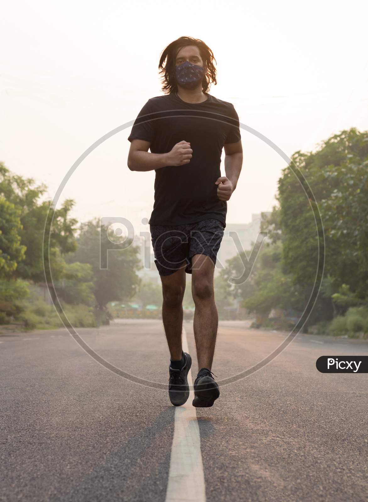 A Man Wearing Mask While Running In The Morning.