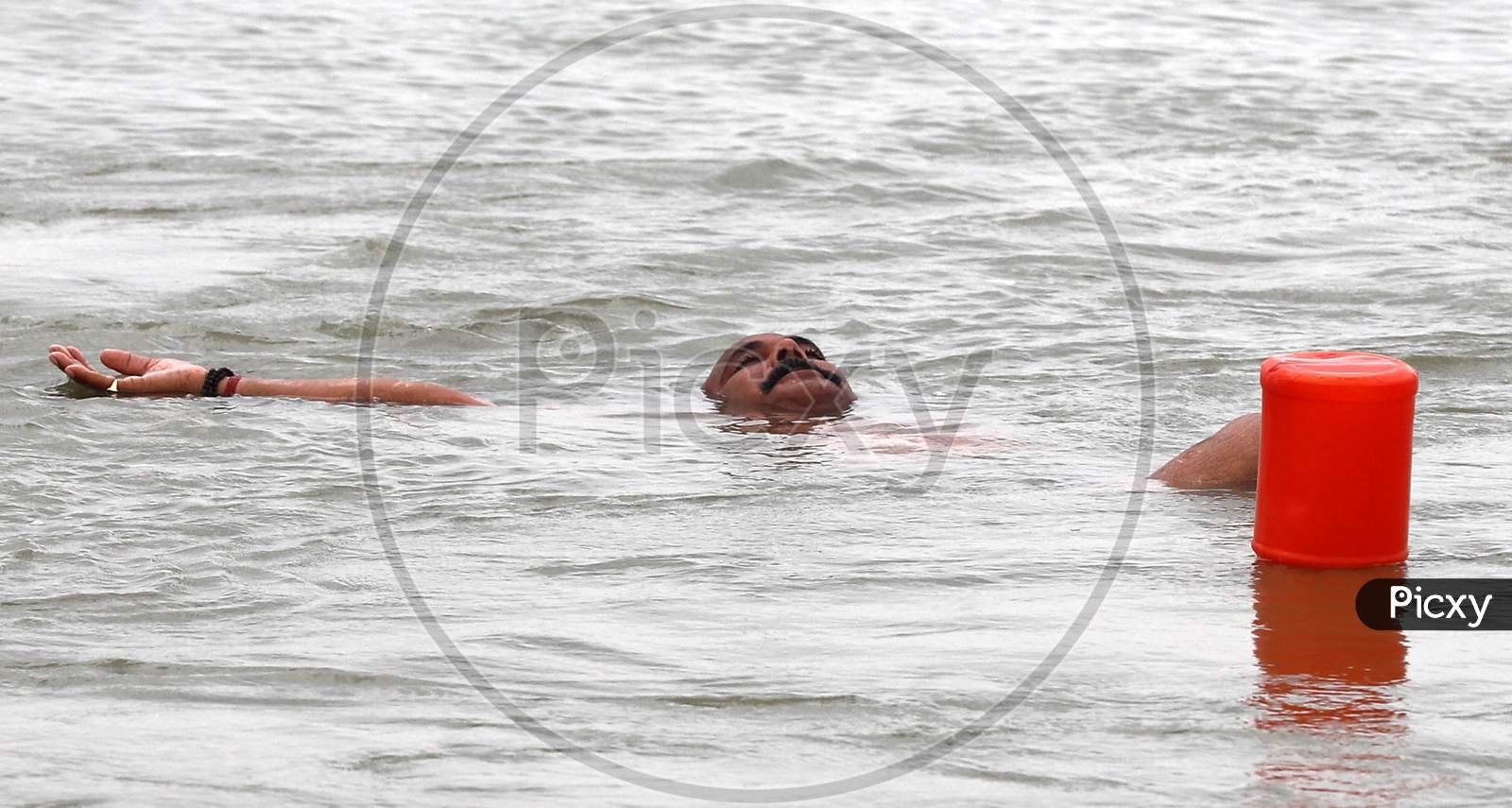 A Man Performs Water Yoga In The Ganga River ahead of International Yoga Day In Prayagraj, June 14, 2020.