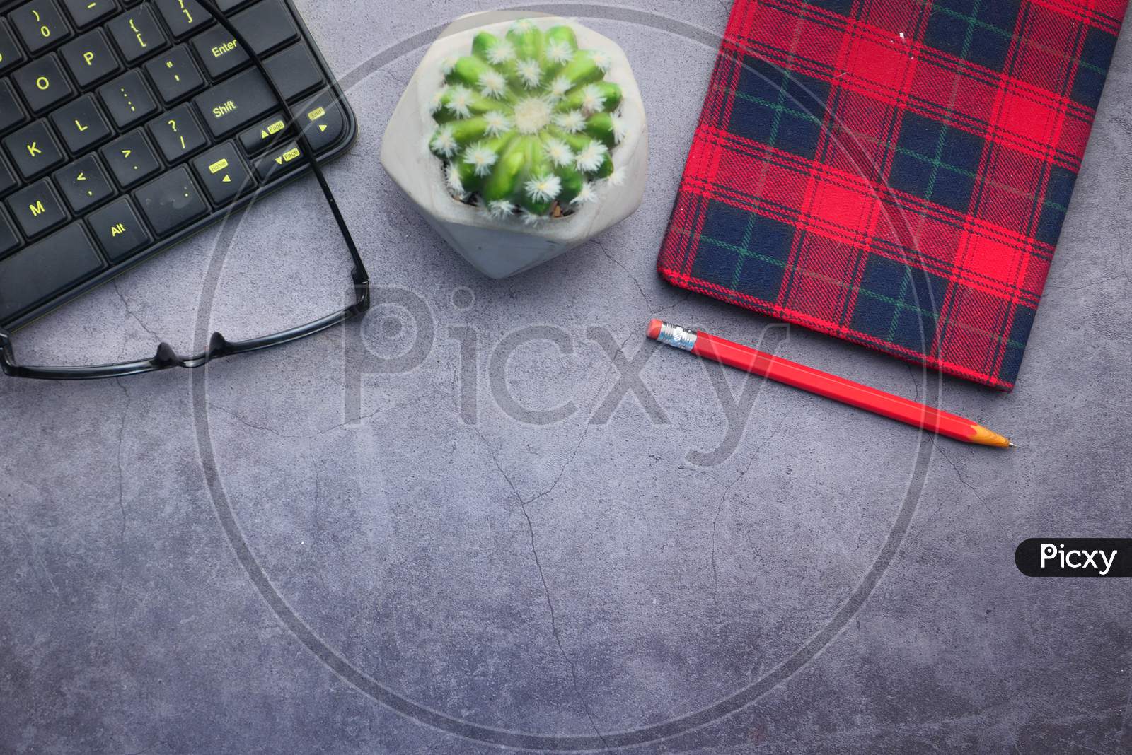 High Angle View Of Eyeglass, Notepad And Keyboard With Copy Space