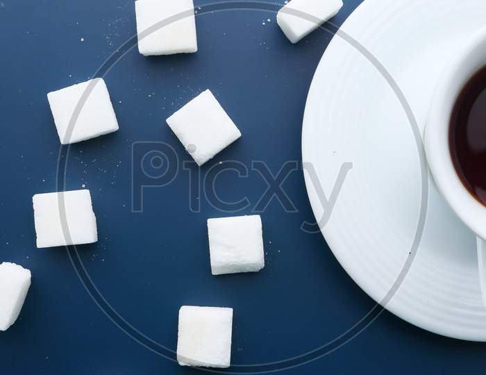 Top View Of Tea And Sugar Cube On Color Background