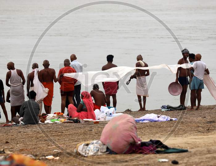 Hindu Devotees Dry Their Clothes After Taking Holy Dip In River Ganga In Prayagraj, June 14, 2020.