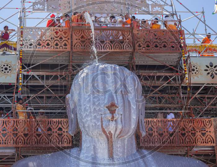 Bahubali deity getting Anointed with Milk in Shravanabelagola/India.