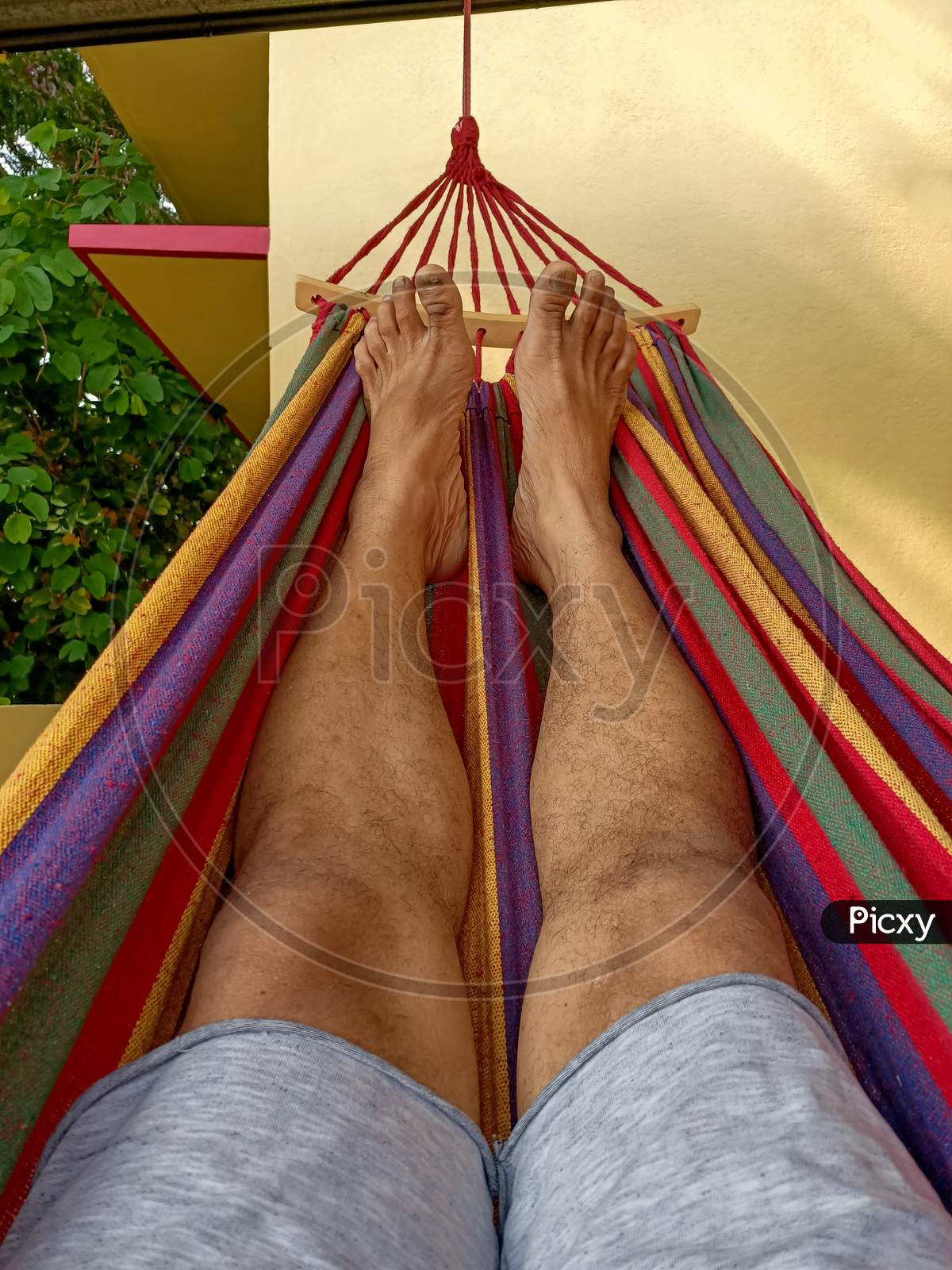 Relaxed legs on a colorful Hammock on a sunny afternoon.