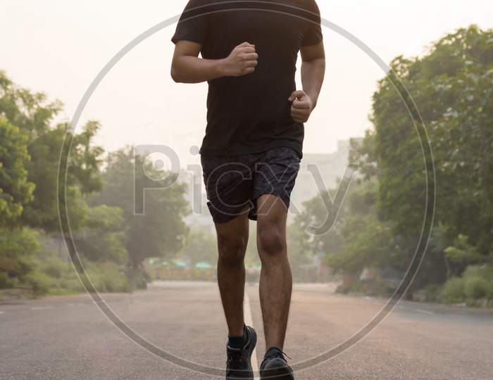 A Man Wearing Mask While Running In The Morning.