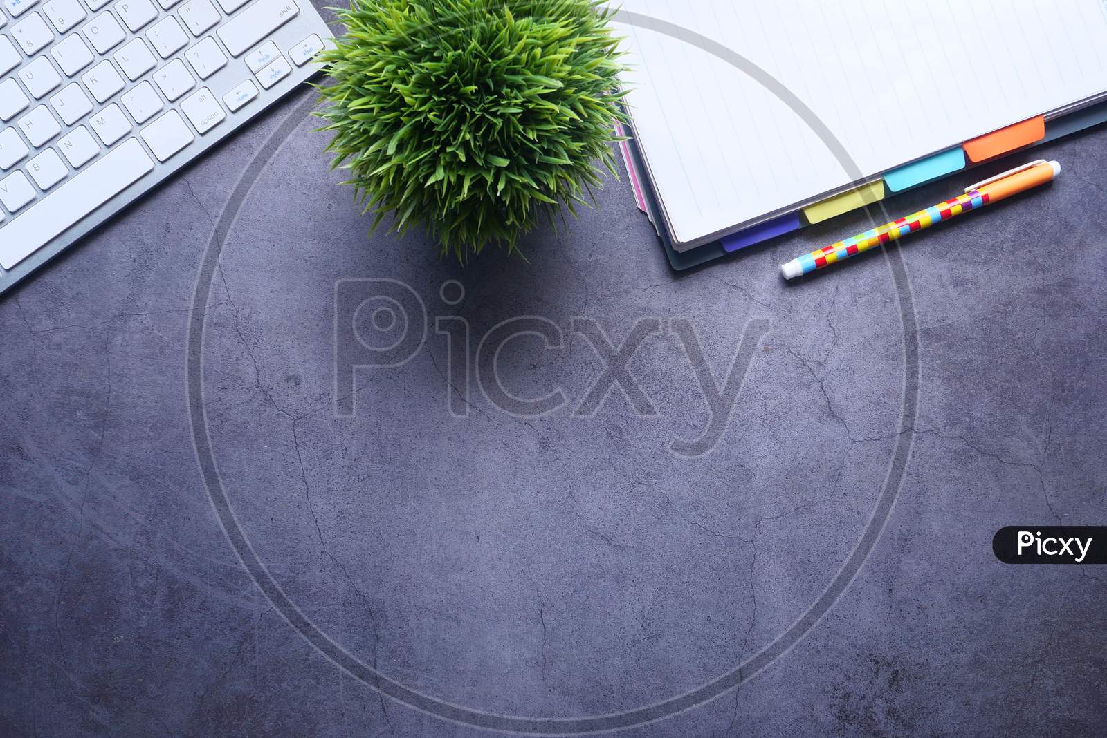 High Angle View Of Notepad, Keyboard On Gray Background With Copy Space