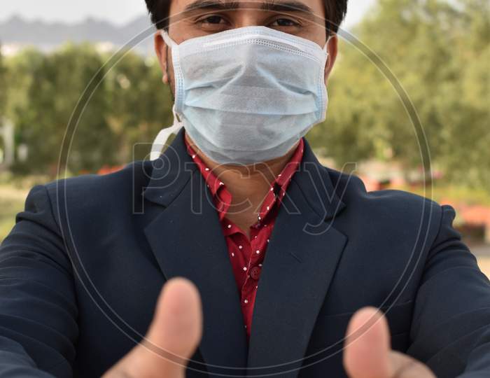 indian businessman with mask and coat