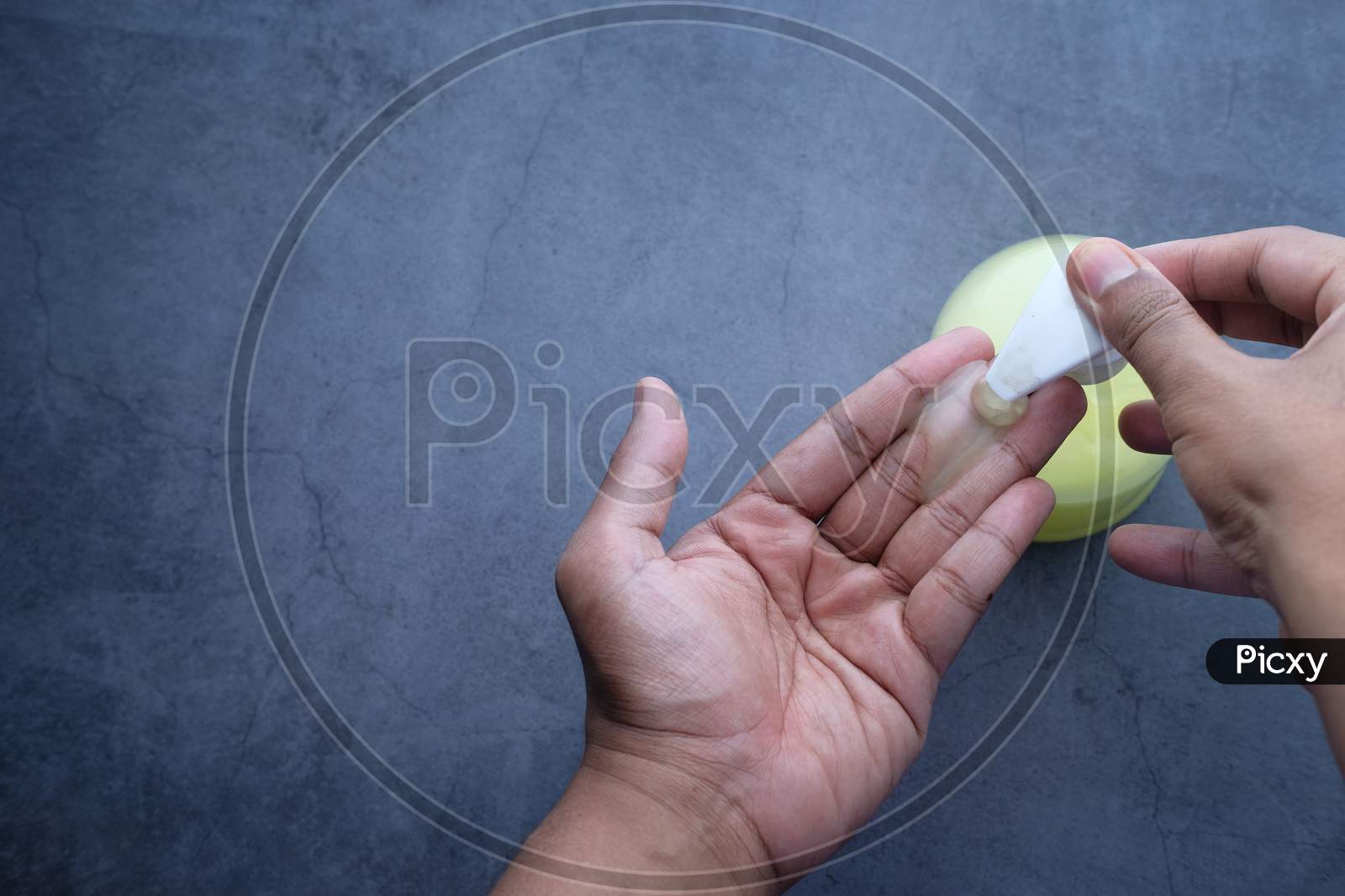 Man'S Hands Using Hand Sanitizer Gel, Top View