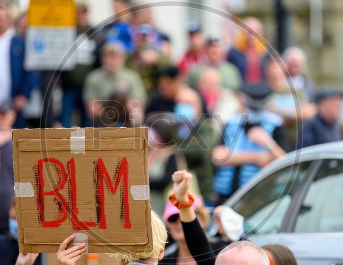 A Homemade Blm Sign Held High At A Black Lives Matter Protest