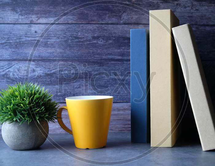 Stack Of Books, Coffee Mug On Desk