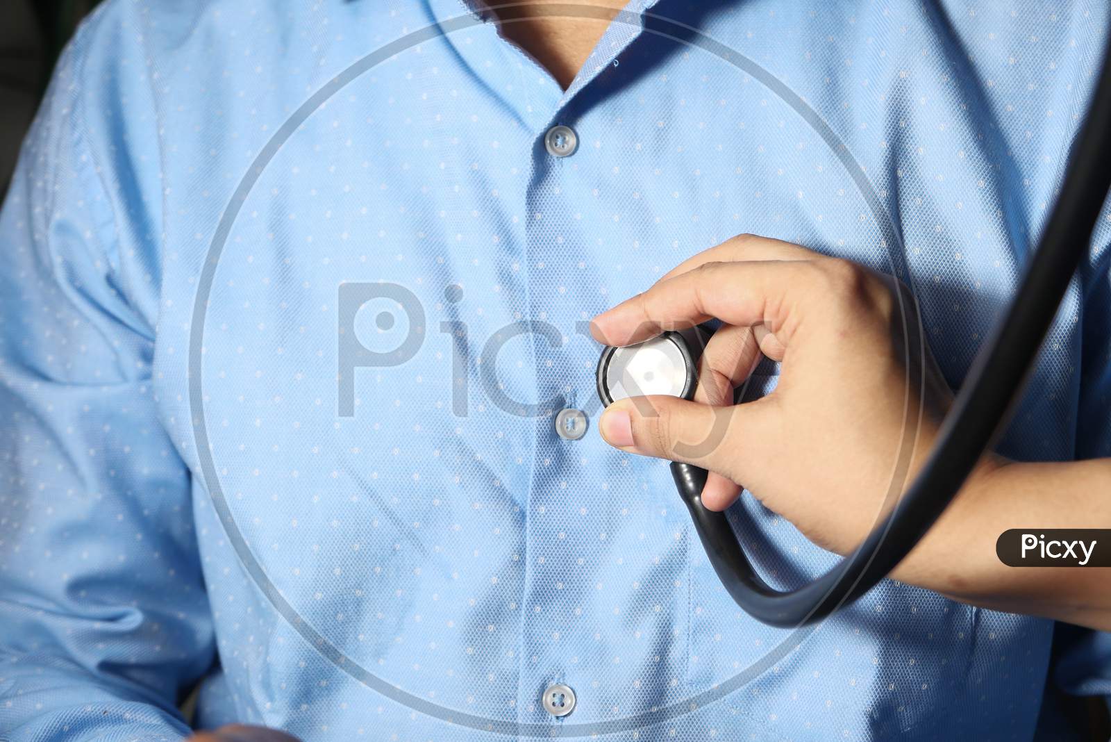 Doctor Using A Stethoscope Checking Body, Close Up