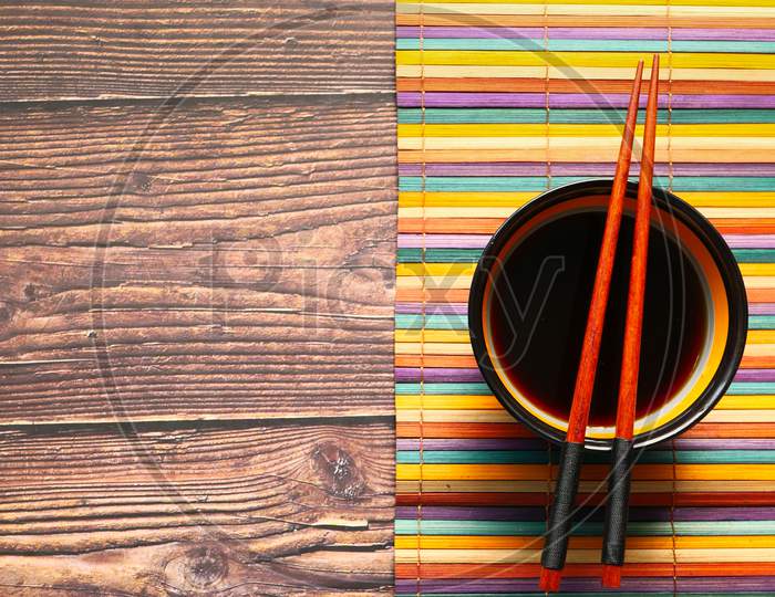 Japanese Food Cooking Set With Soy Sauce, Bamboo Sticks On Wooden Table.