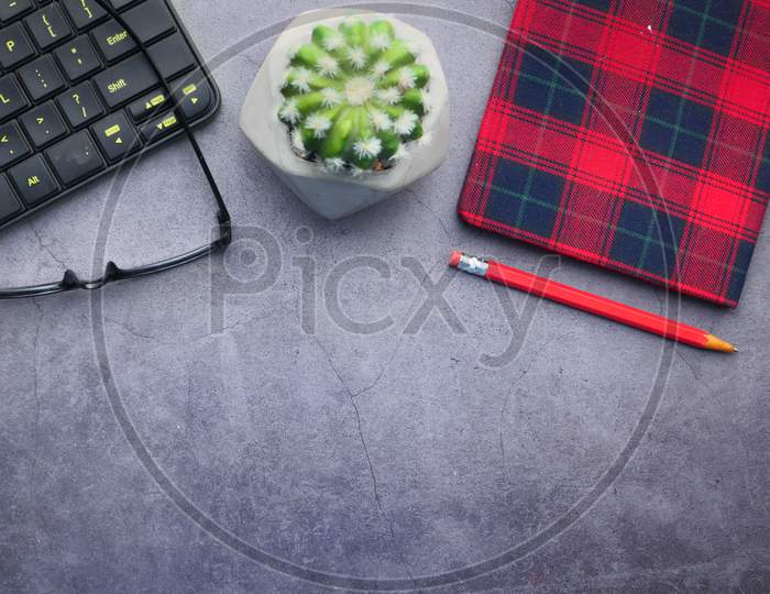 High Angle View Of Eyeglass, Notepad And Keyboard With Copy Space
