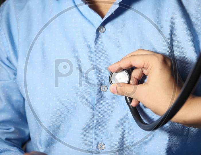 Doctor Using A Stethoscope Checking Body, Close Up