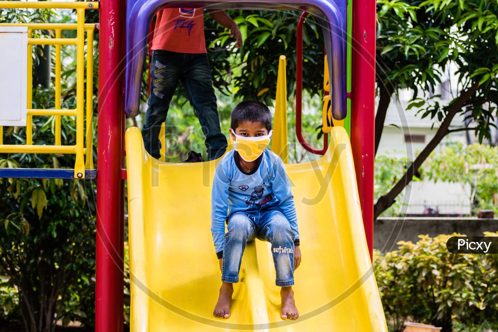 A Little Boy Playing In A Park While Wearing A Mask After Covid 19 Lockdown Has Been Lifted In India