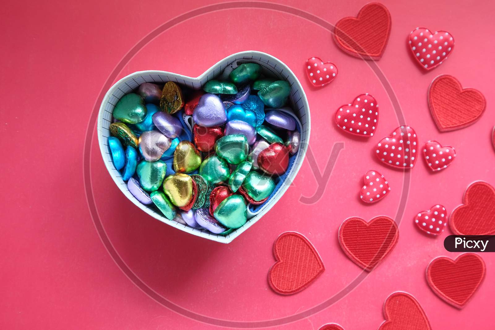Heart Shape Gift Box With Candy On Red Background