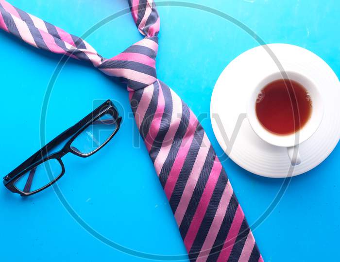 Father'S Day Concept. Men'S Tie, Glasses, Coffee On Blue Background Top-Down.
