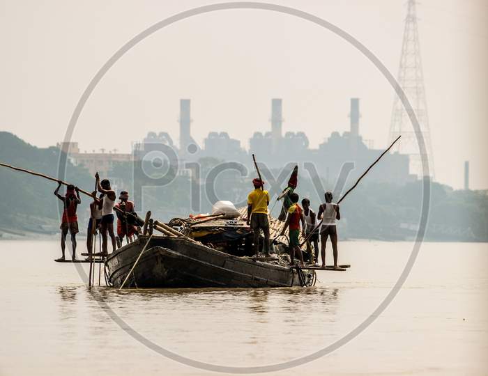 Fishermen on their boat at Hooghly river in Kolkata cityscape/West Bengal/India.